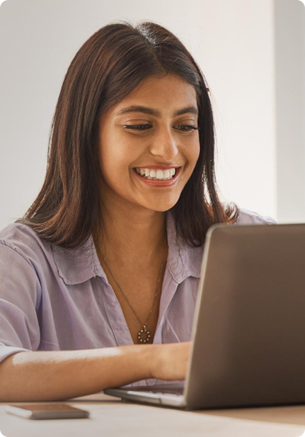 Woman smiling at laptop